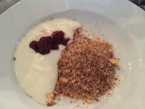 Picture of bowl with crushed nuts, yoghurt and berries